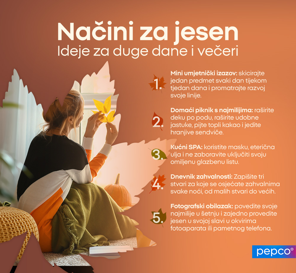Mama i dijete prave girlandu od šarenih lišća, smješeći se jedno drugom u svijetloj, sunčanoj sobi.